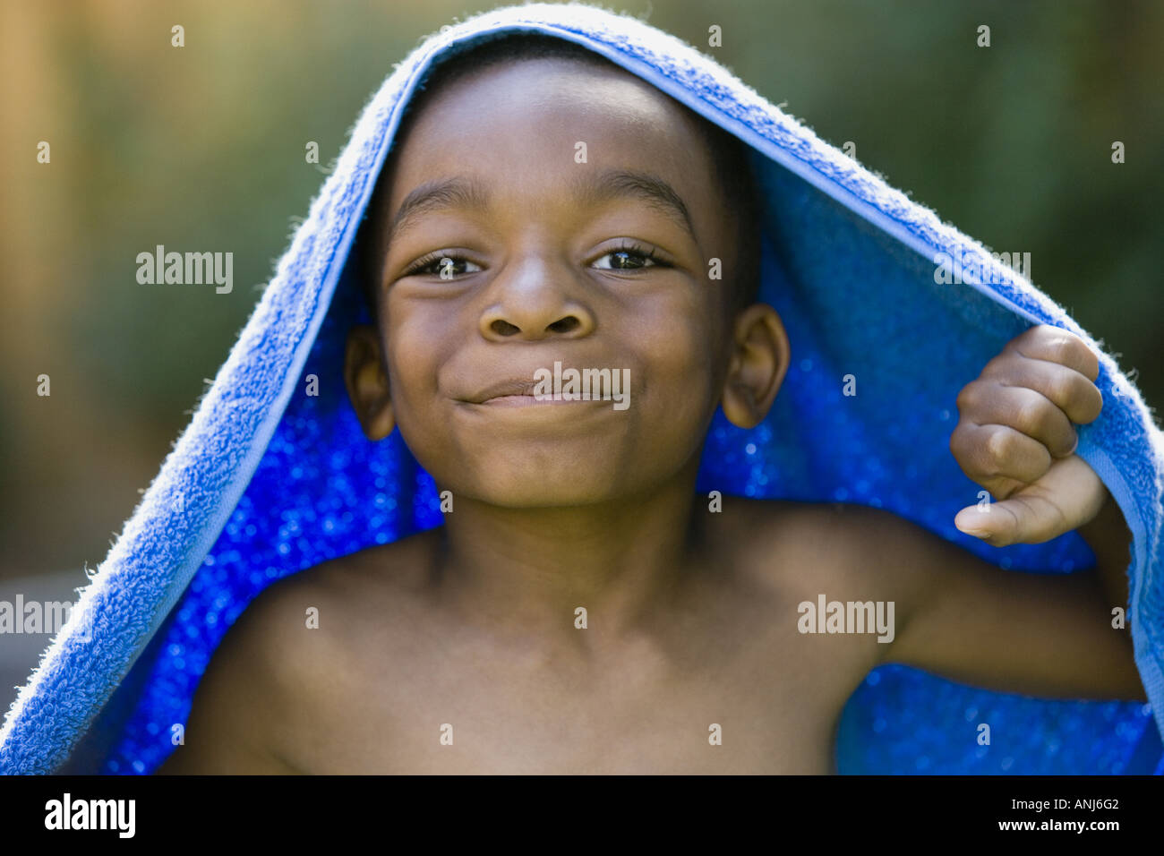 Portrait of a boy smiling with a towel on his head Stock Photo