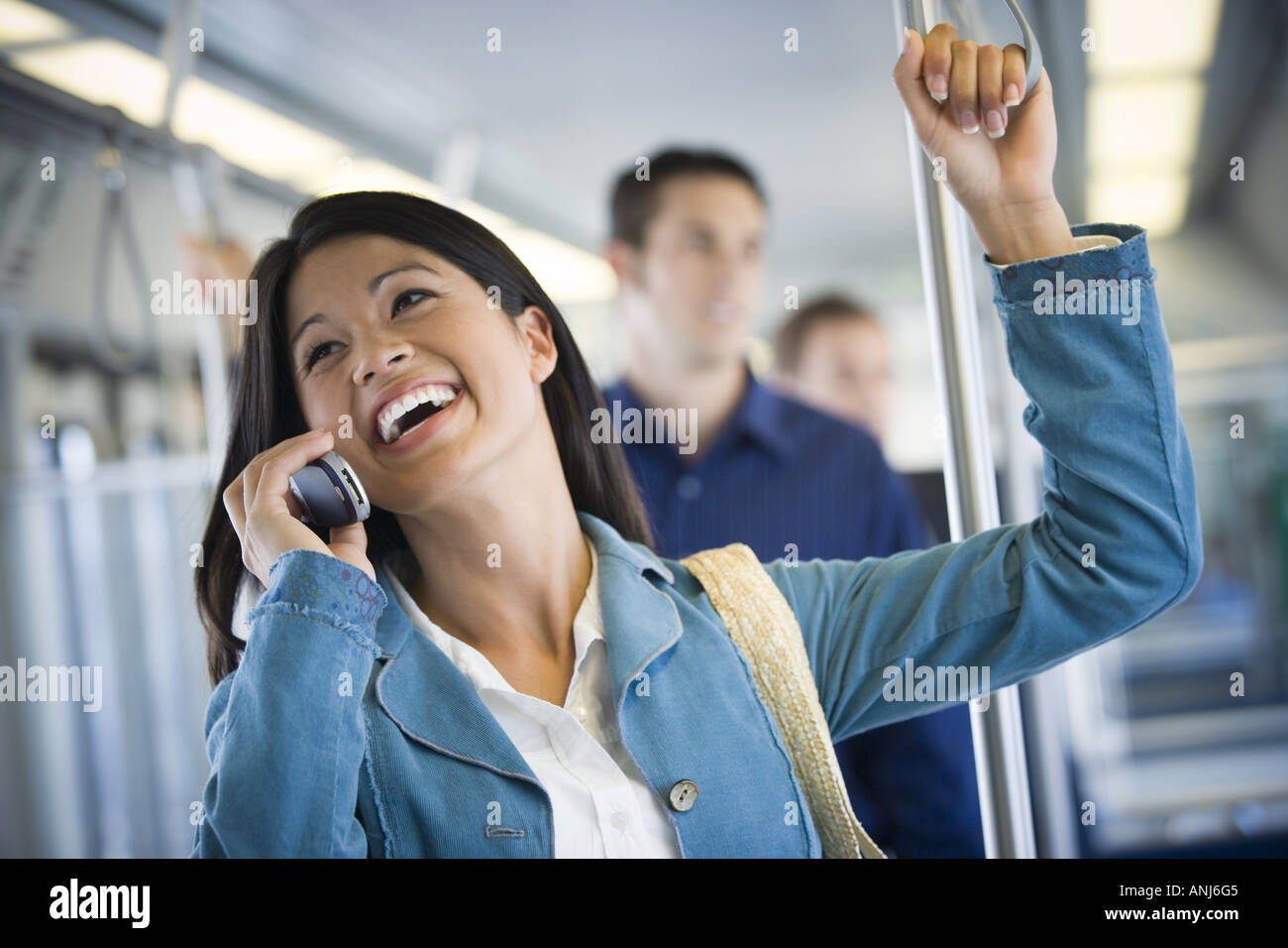 Young woman talking on a mobile phone in a passenger train Stock Photo