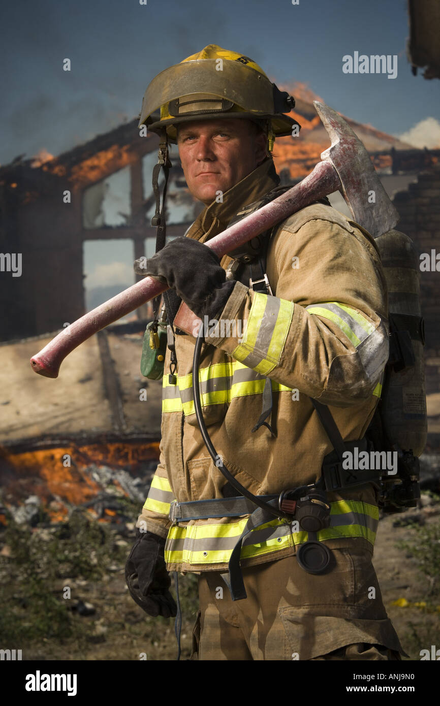 Portrait of a firefighter holding an axe Stock Photo