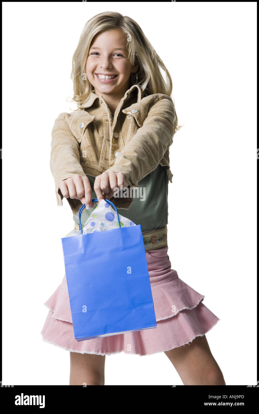 Portrait of a girl showing a shopping bag and smiling Stock Photo