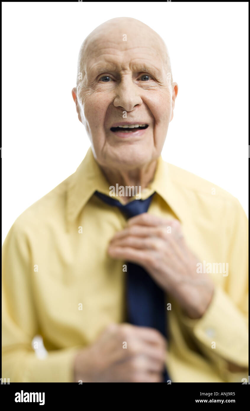 Portrait of a senior man adjusting his tie Stock Photo