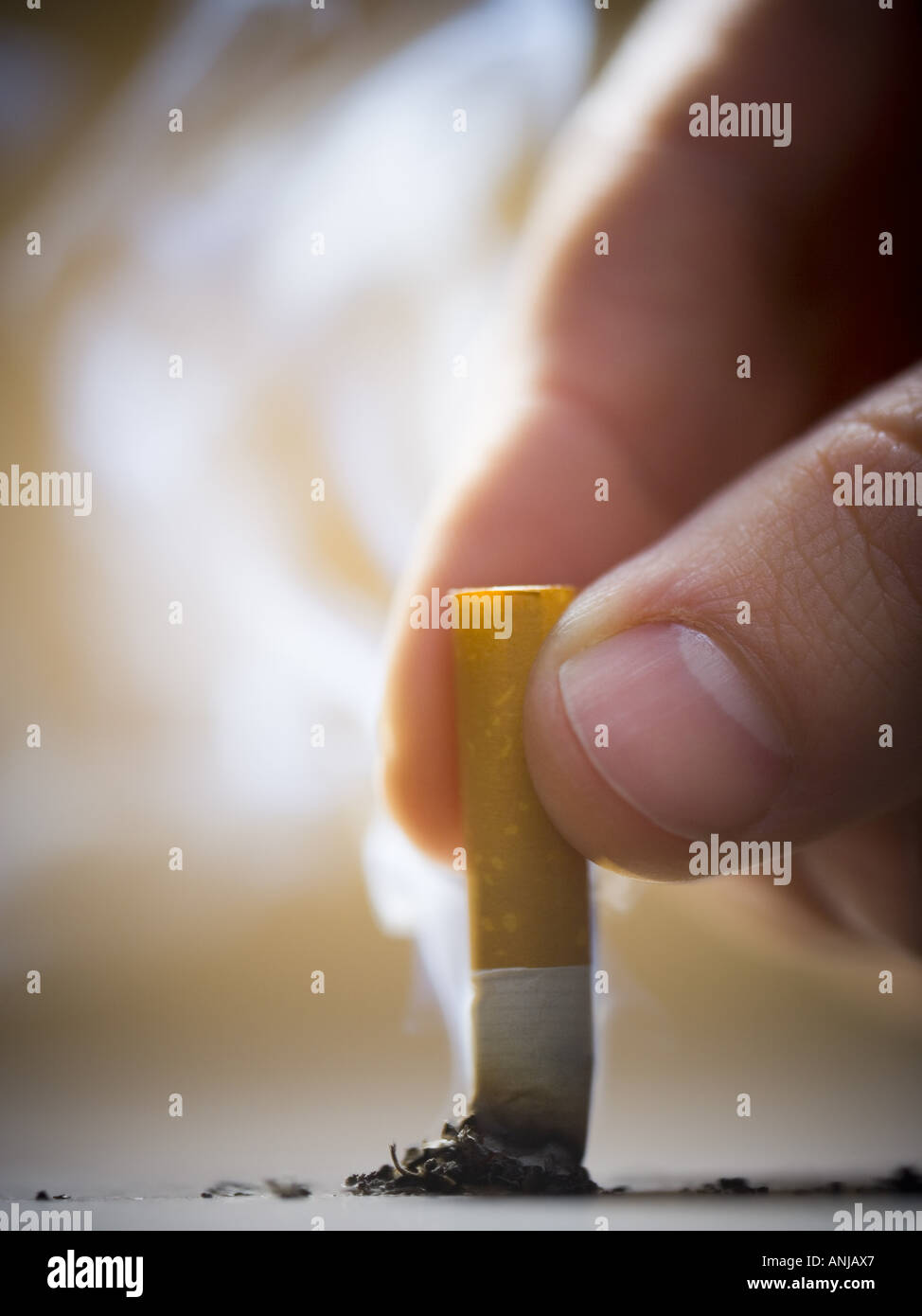 Close up of a man putting out a cigarette Stock Photo