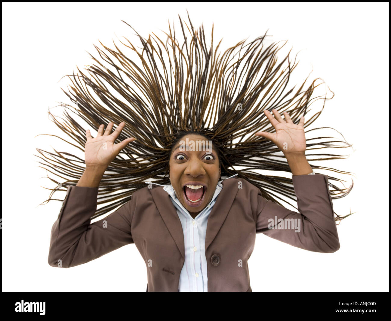 Portrait of a businesswoman shouting with her arms raised Stock Photo