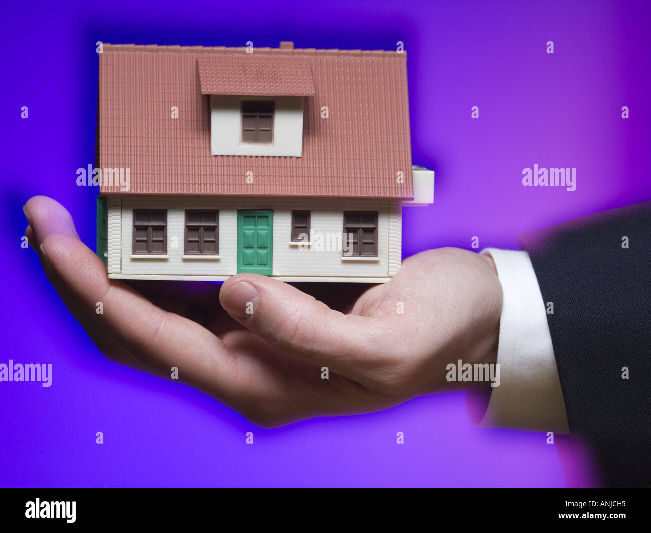 Close up of the model of a house on a man s palm Stock Photo
