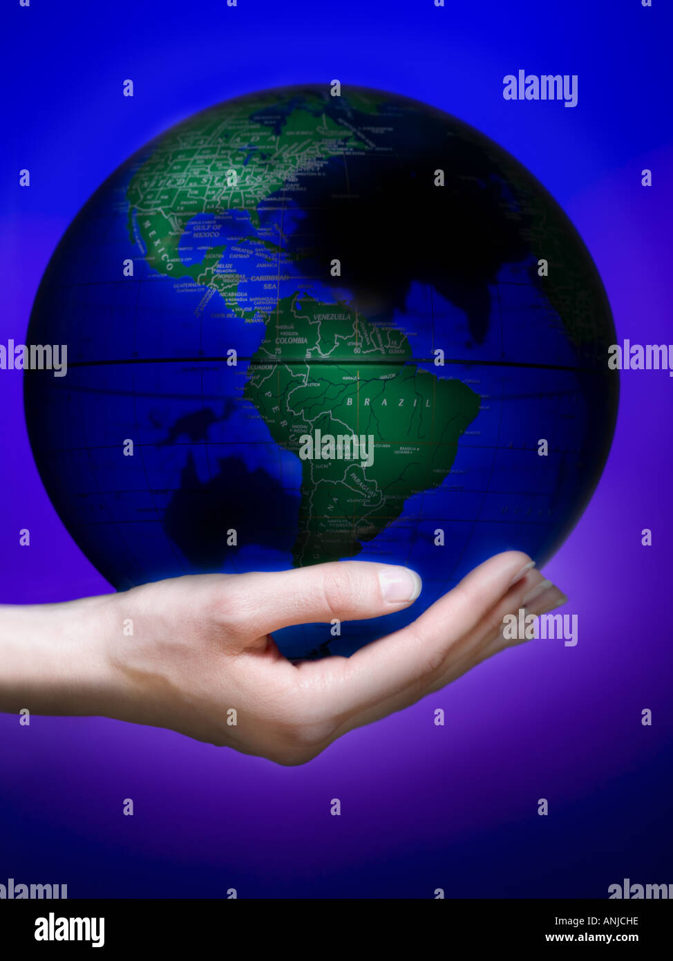 Close up of a human hand holding a globe Stock Photo