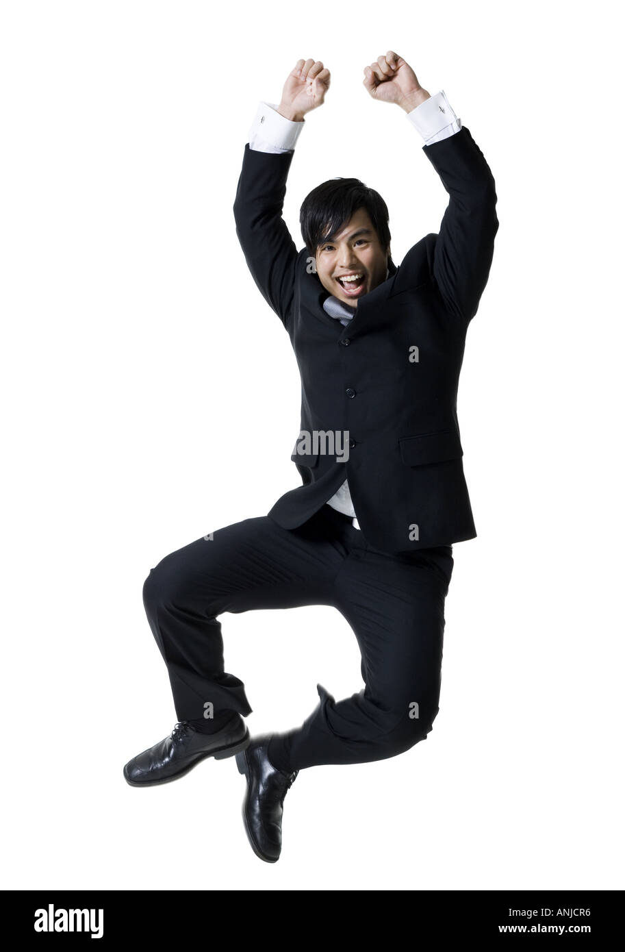 Low angle view of a business man jumping in mid air Stock Photo