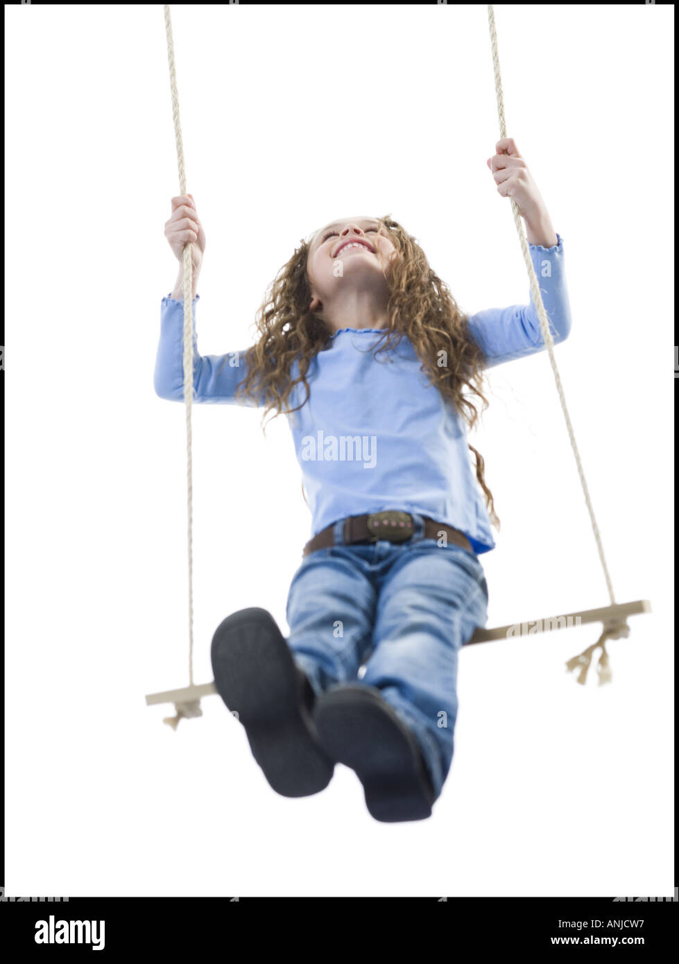 Low angle view of a girl on a swing Stock Photo
