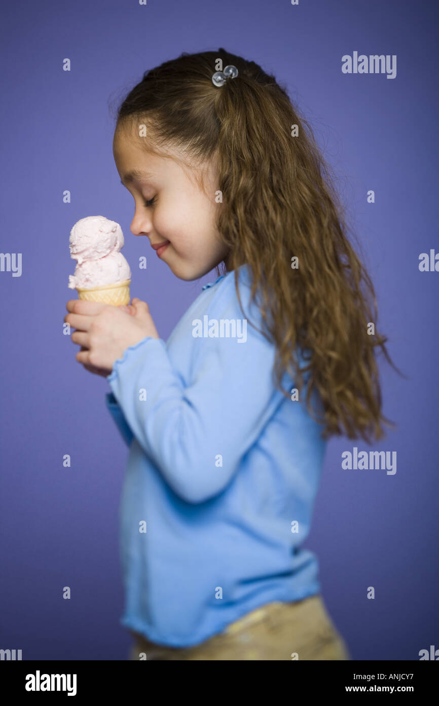 Profile of a girl holding an ice cream cone Stock Photo