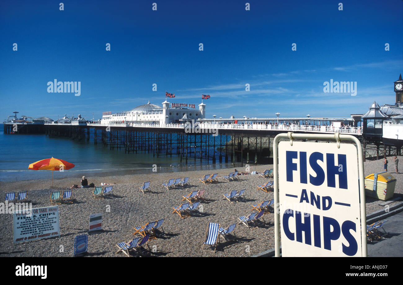 Brighton Pier with deckchairs on beach and fish and Chips sign Brighton
