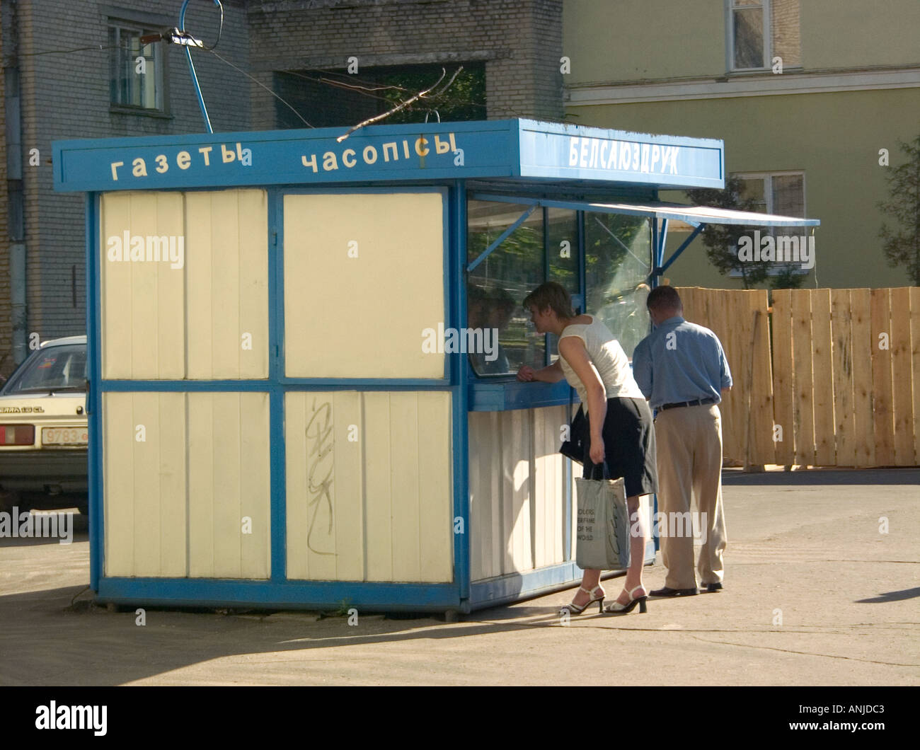 Woman looking in window of pavement shopping kiosk in Gomel Belarus Stock Photo