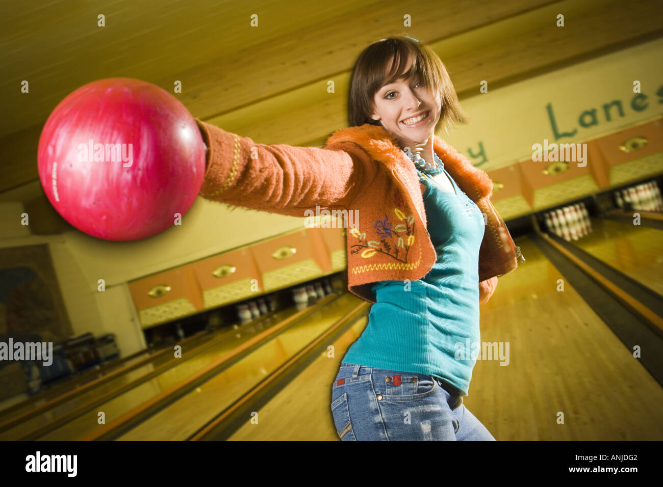 Close up of a young woman holding a bowling ball Stock Photo