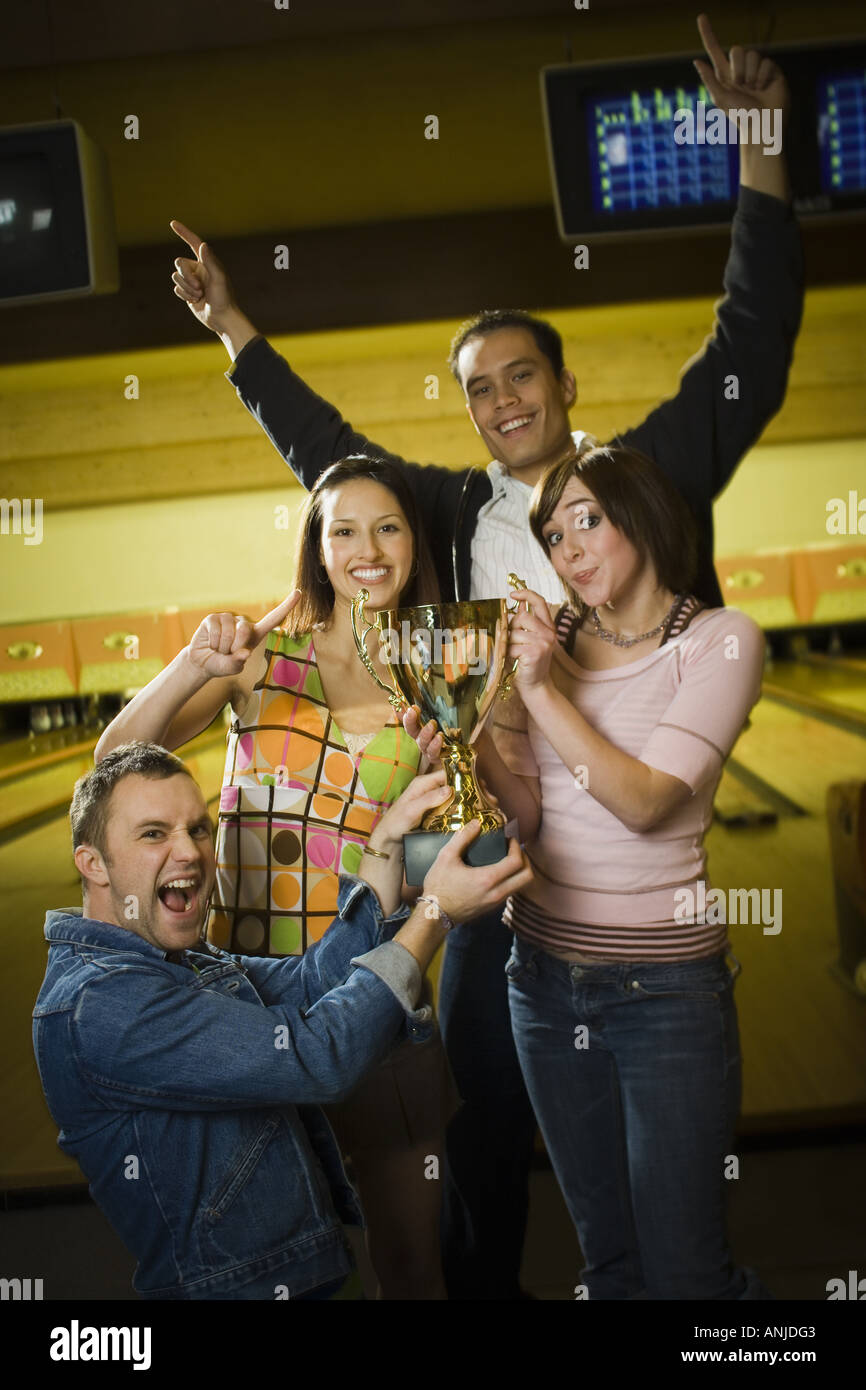 Group of young adults holding a trophy Stock Photo