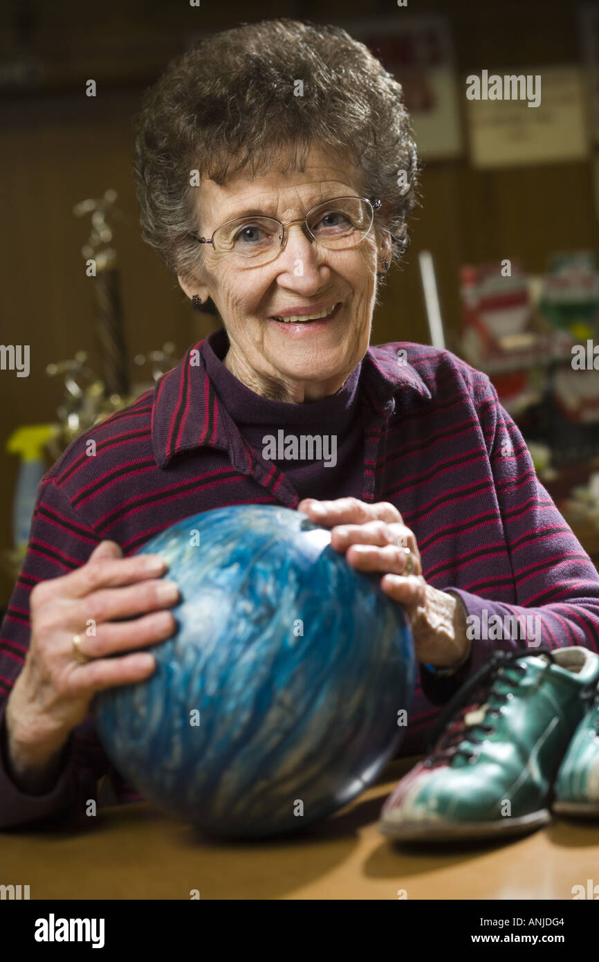 Portrait of a senior woman holding a bowling ball Stock Photo