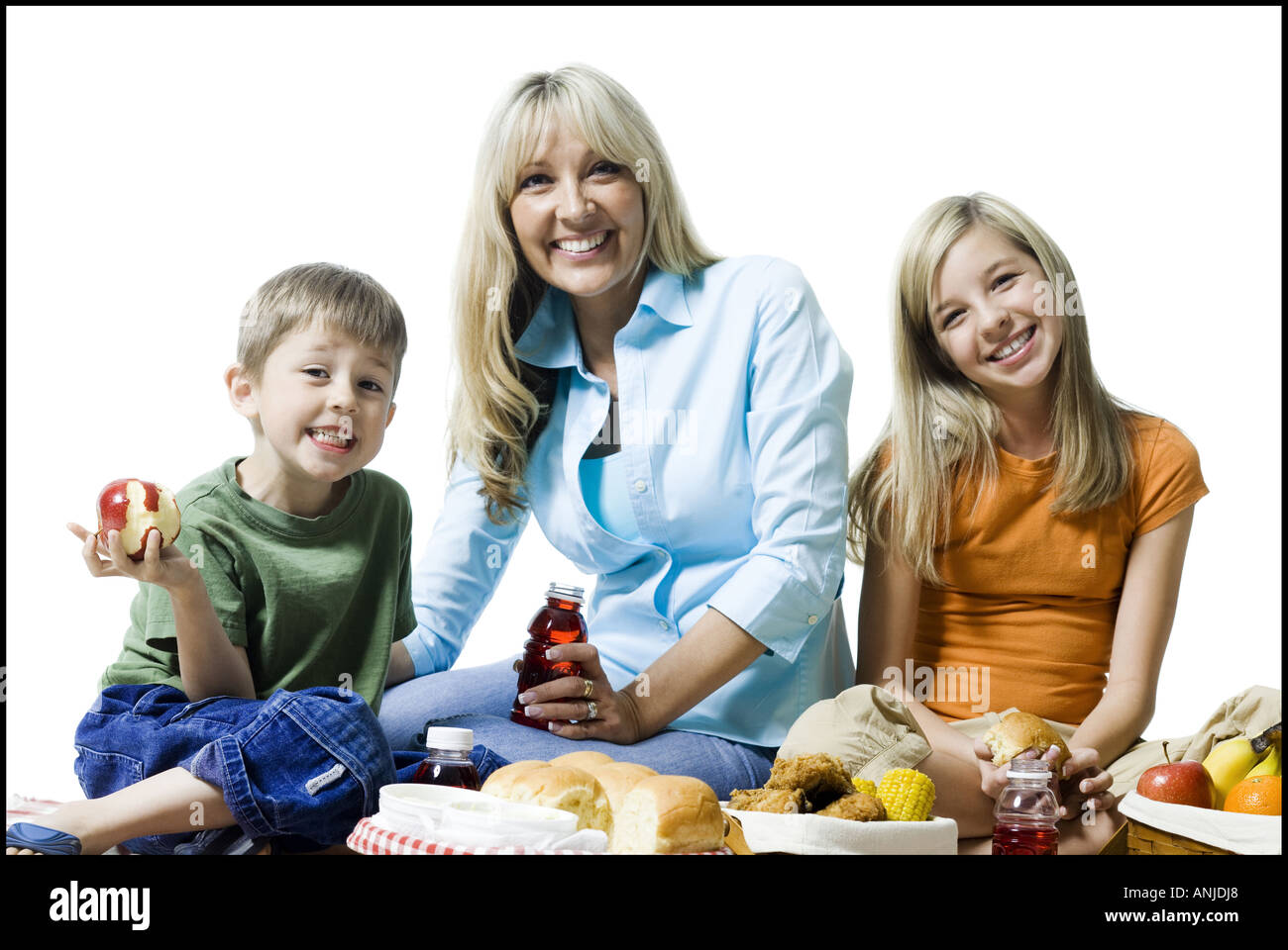 Portrait of a woman and her two children having a picnic Stock Photo