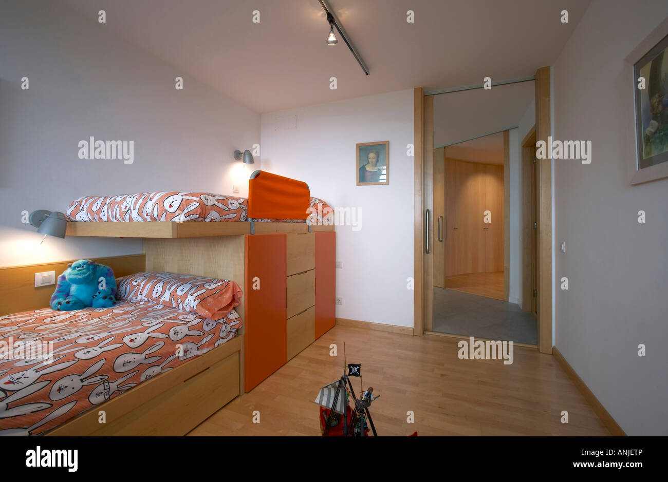 Children s room with stuffed toy on bed wood flooring Stock Photo