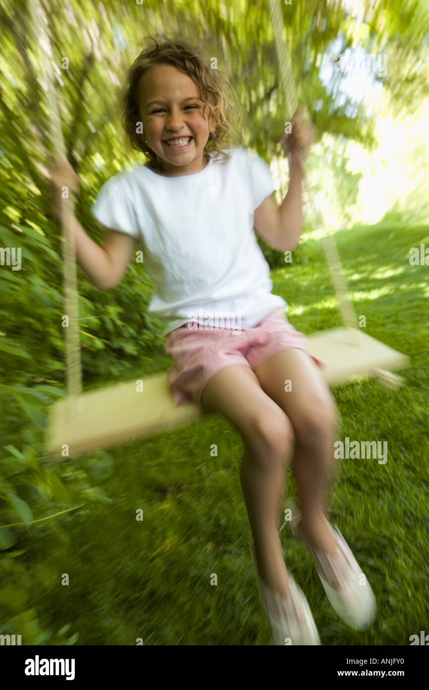Portrait of a girl sitting on a swing Stock Photo - Alamy
