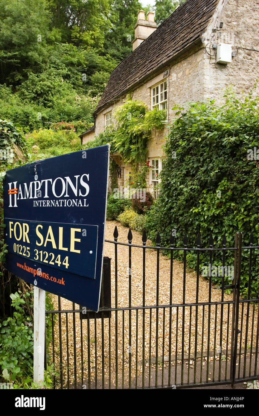 UK Wiltshire Castle Combe High Street for sale sign outside character property Stock Photo