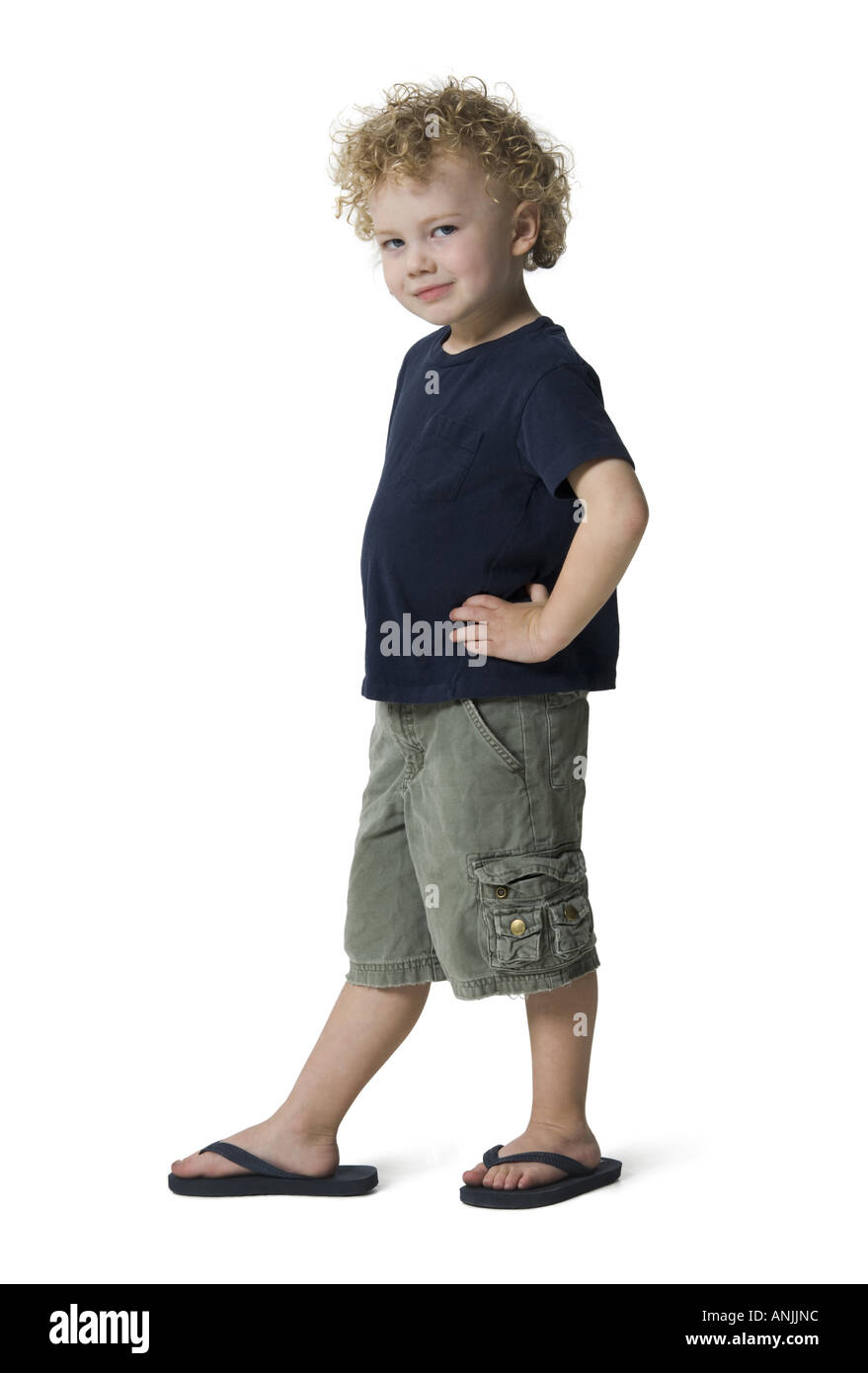 Portrait boy standing arms akimbo Cut Out Stock Images & Pictures - Alamy