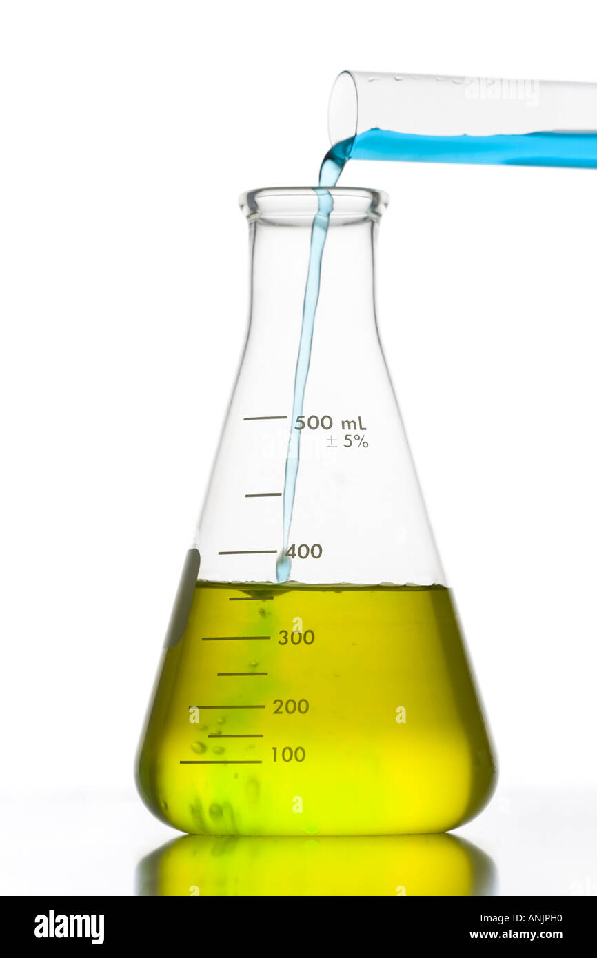 Liquid being poured into a conical flask with a test tube Stock Photo