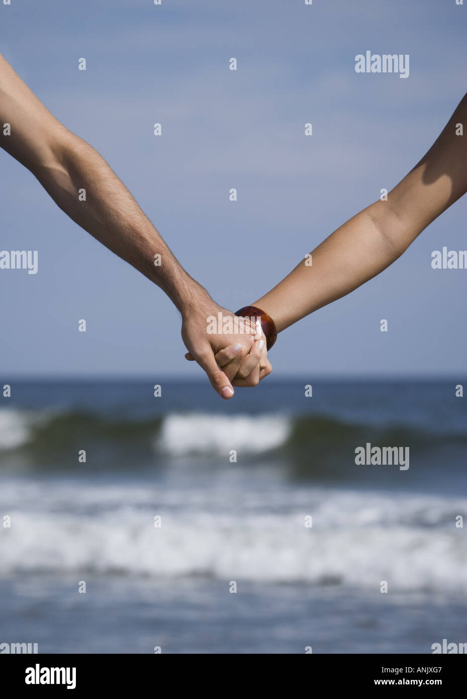 Two people holding hands shoreline hi-res stock photography and images ...
