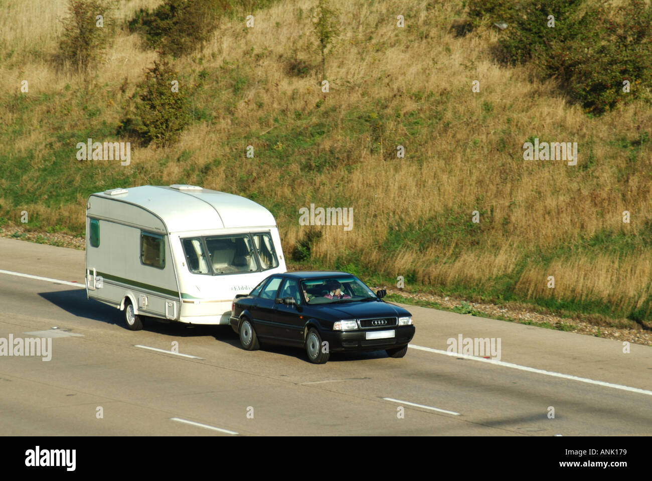 M25 motorway car towing caravan Stock Photo Alamy