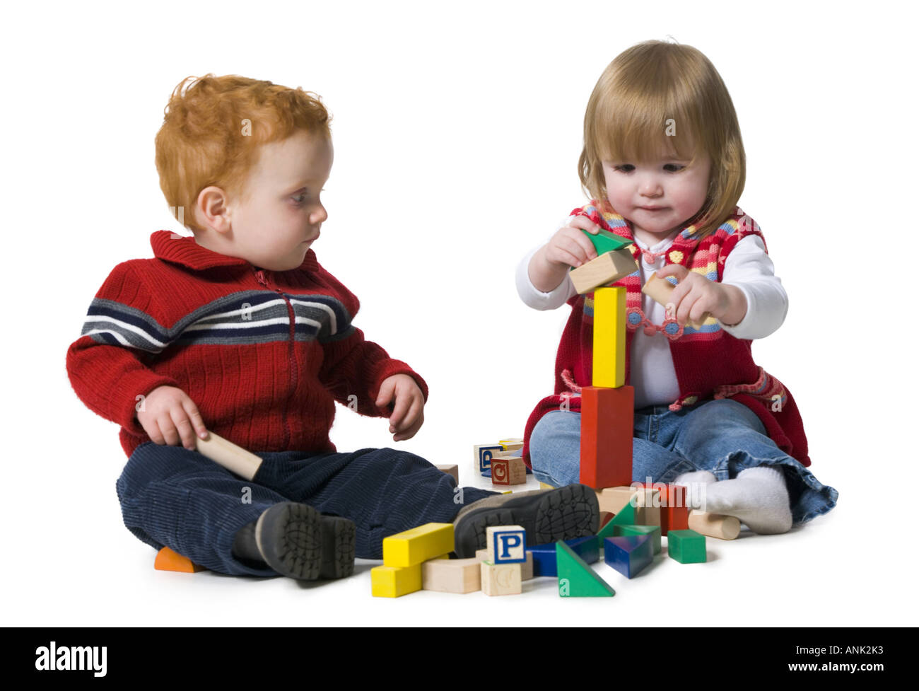 Two children playing with building blocks Stock Photo - Alamy