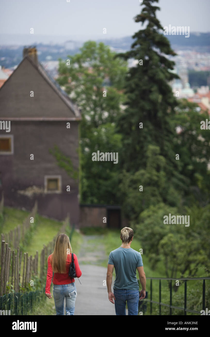Rear view of a teenage couple walking on a path Stock Photo - Alamy