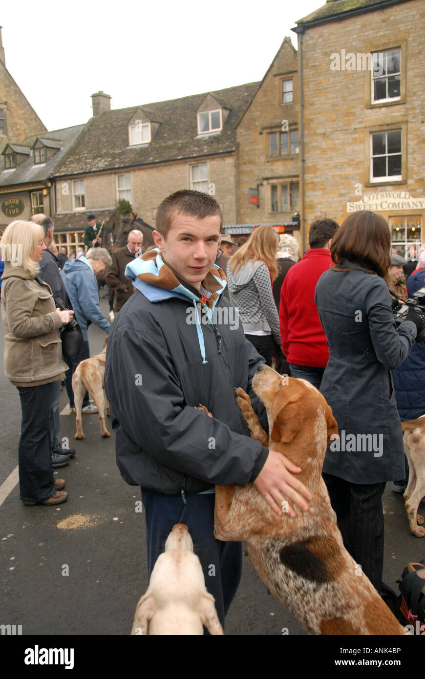 Teenage boy interacting with foxhound New Year s Day Meet Stow on the Wold Gloucestershire Stock Photo