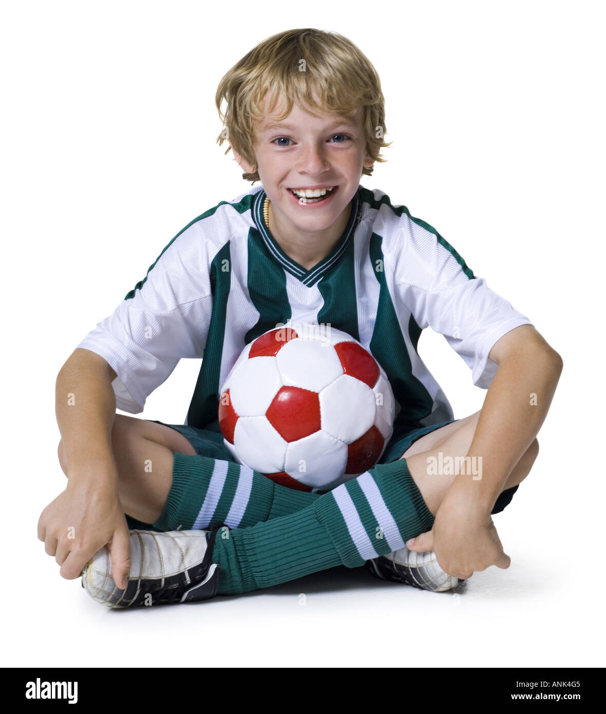 Portrait of a boy sitting with a soccer ball Stock Photo