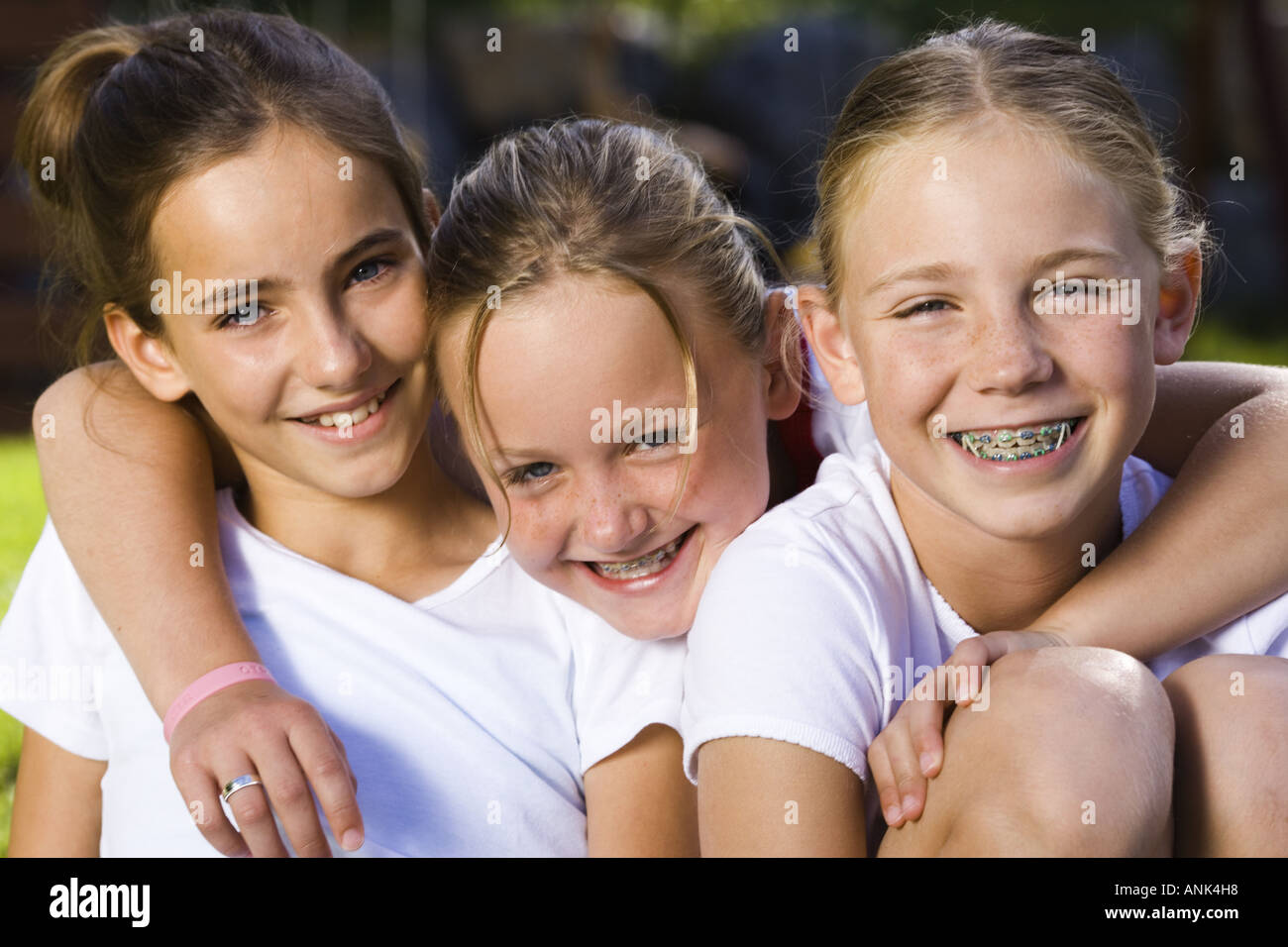 Portrait of three girls smiling Stock Photo - Alamy