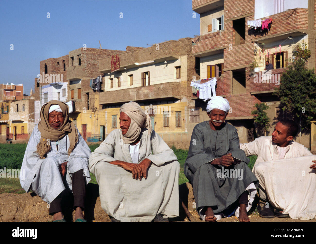 Egyptian men in traditional robes sitting by the roadside Stock Photo