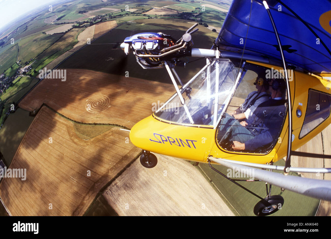Thruster Sprint microlight aircraft over crop circles near Avebury in Wiltshire uk Stock Photo