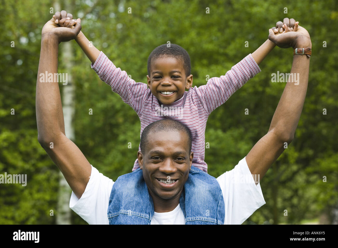 Portrait of a father carrying his son on his shoulders Stock Photo - Alamy