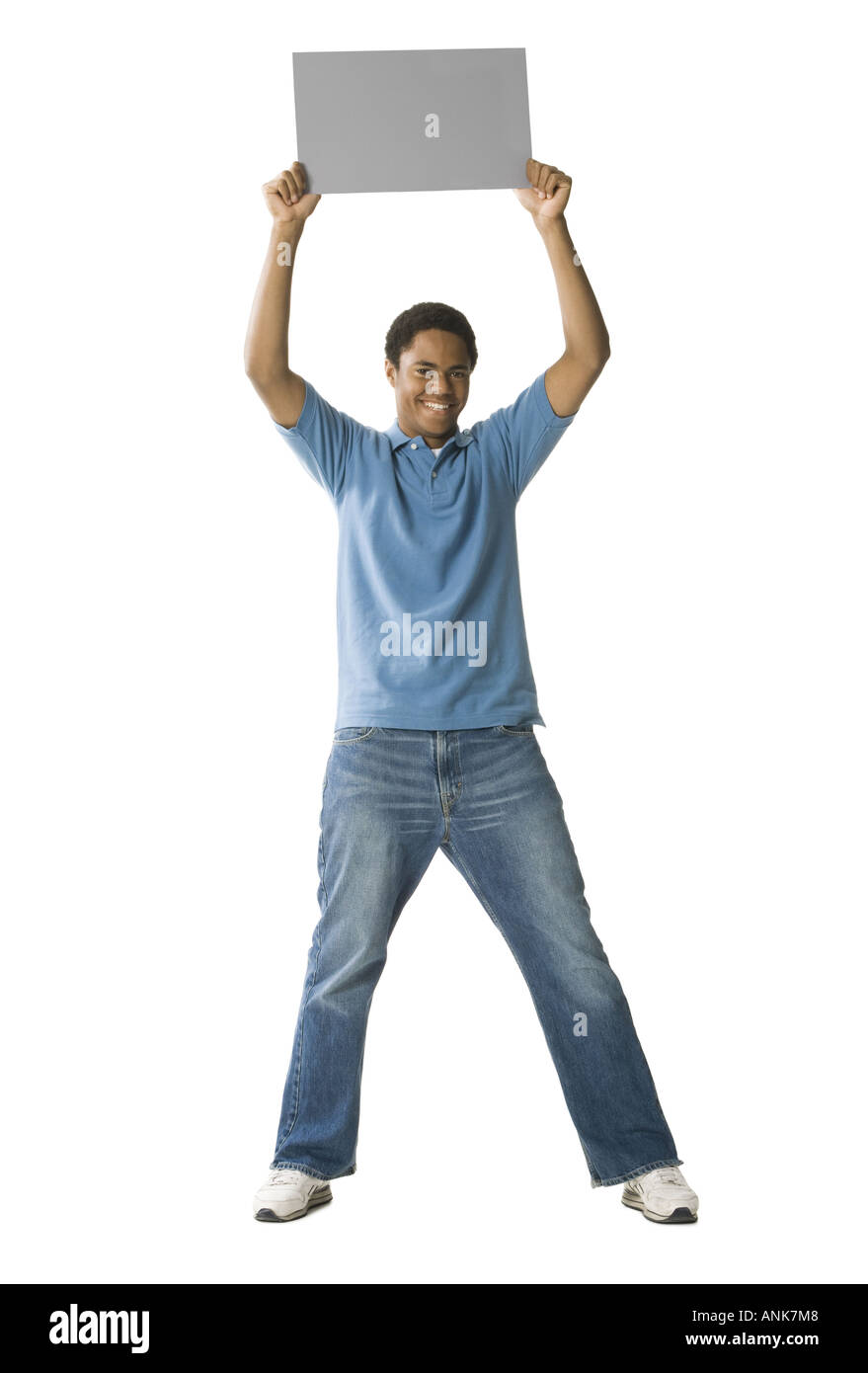 Portrait of a teenage boy holding up a blank sign Stock Photo - Alamy