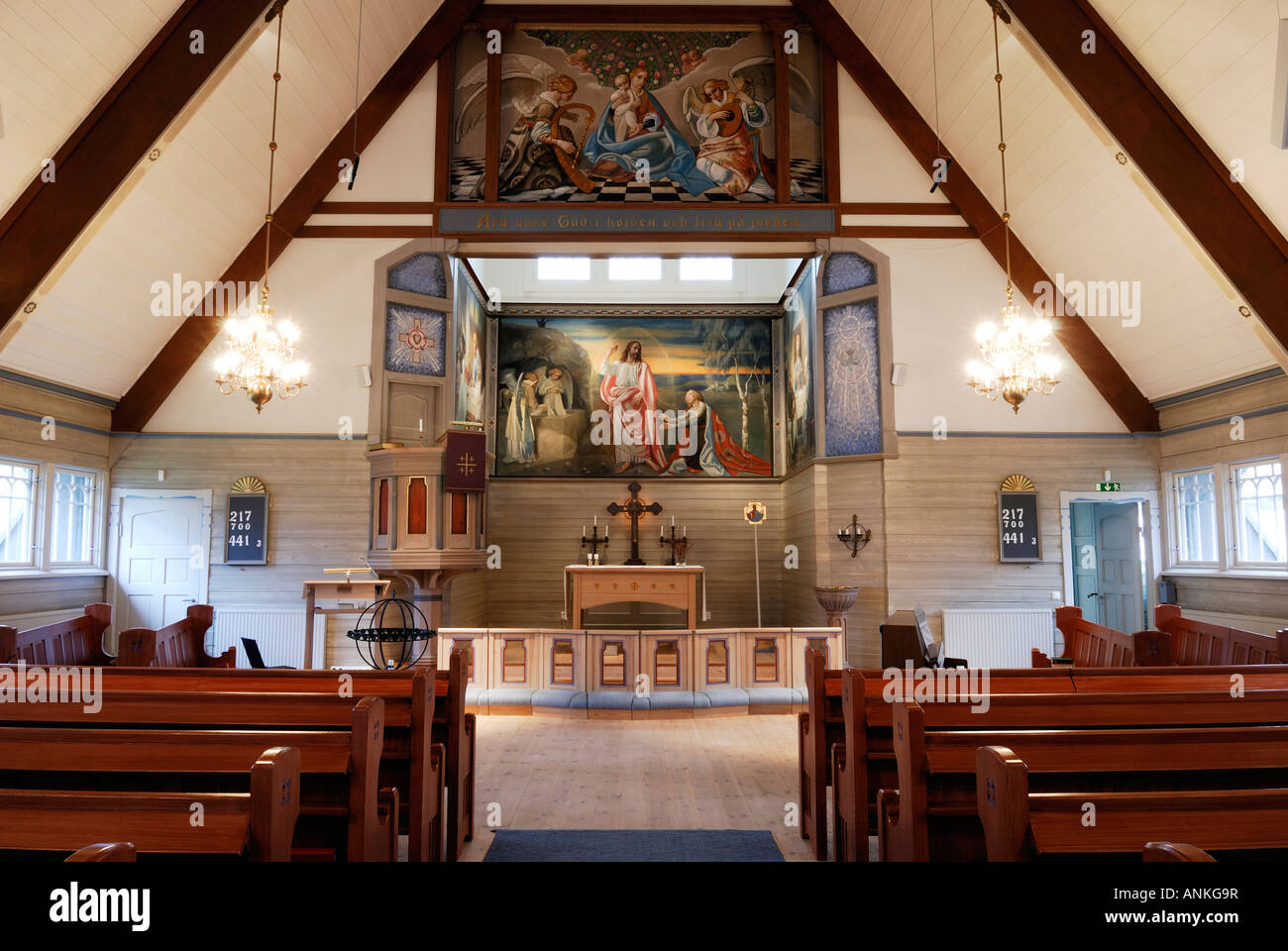 Interior of church altar and pews with mural of Jesus Stock Photo