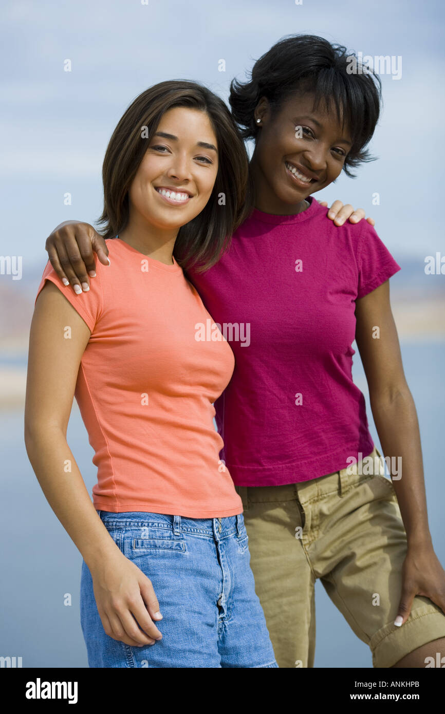 Portrait of two young women smiling Stock Photo - Alamy
