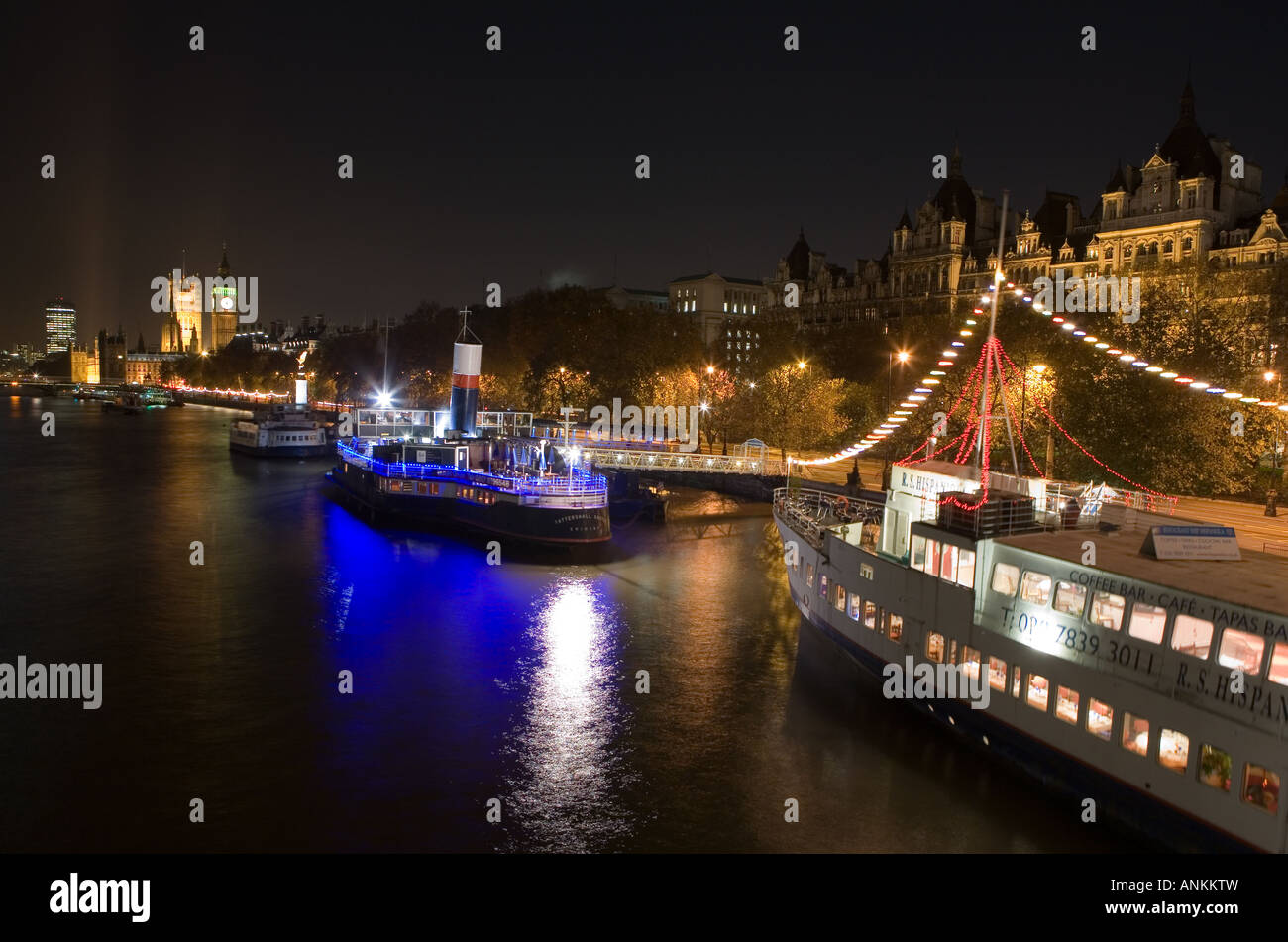 Floating pub and restaurants docked along the River Thames in front of Big Ben in London, England. Stock Photo
