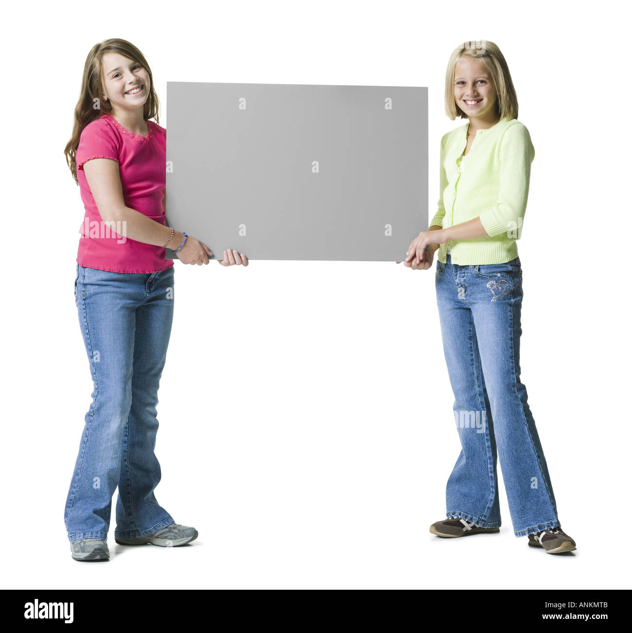 Two young girls holding a blank sign Stock Photo - Alamy