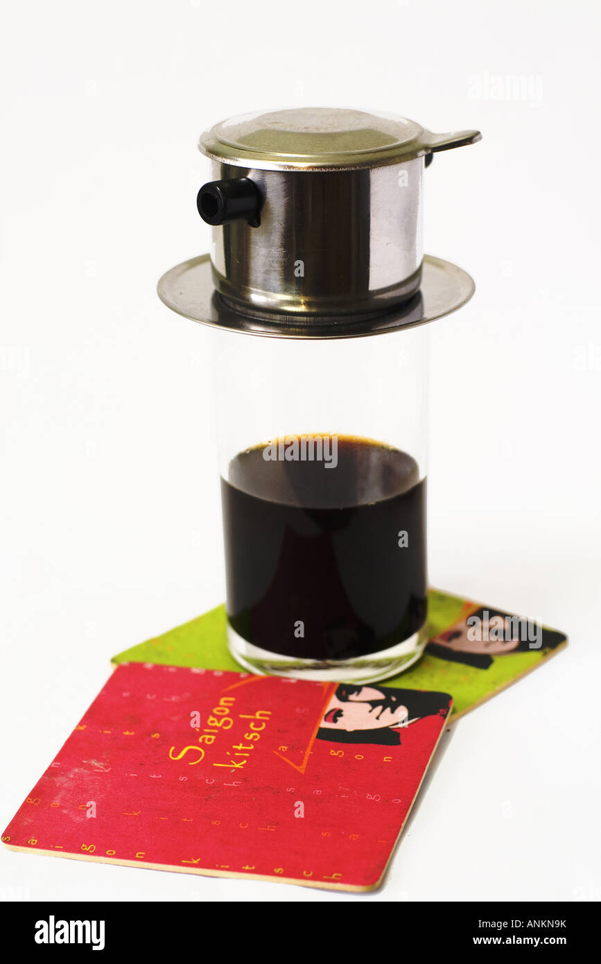 A Vietnamese coffee maker sitting on a glass Stock Photo Alamy