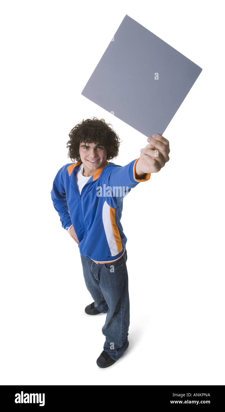 High angle view of a teenage boy holding a blank sign and smiling Stock ...