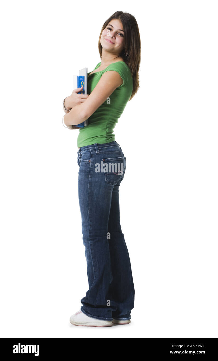 Profile of a teenage girl standing holding notebooks and smiling Stock ...