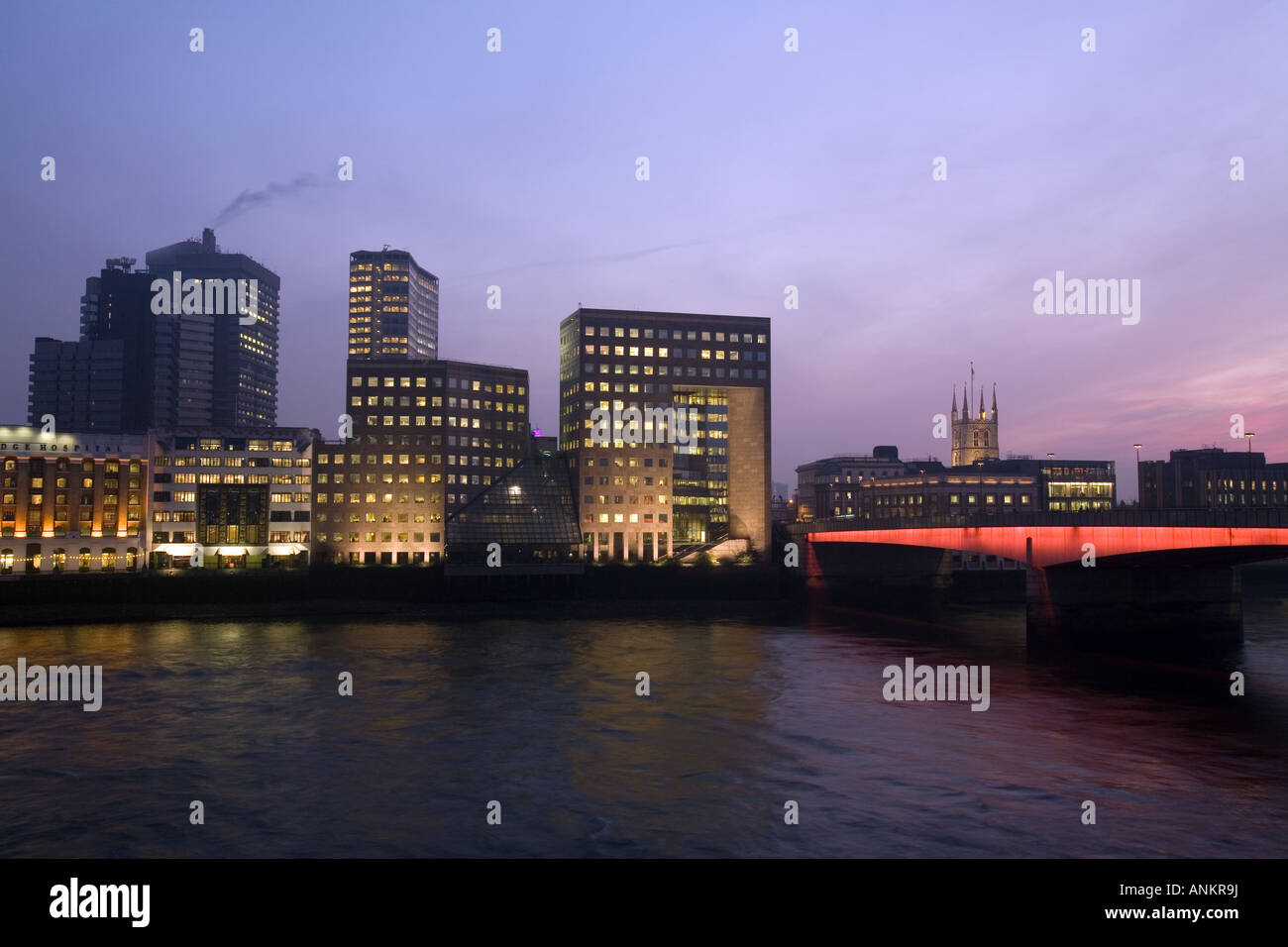 London, England. London Bridge and office buildings along the Thames River Stock Photo