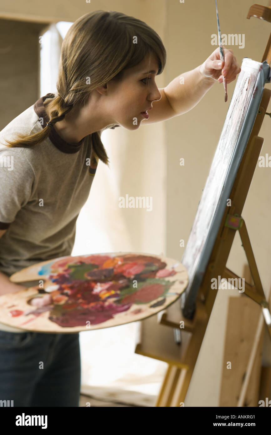 Young woman painting canvas in hi-res stock photography and images - Alamy