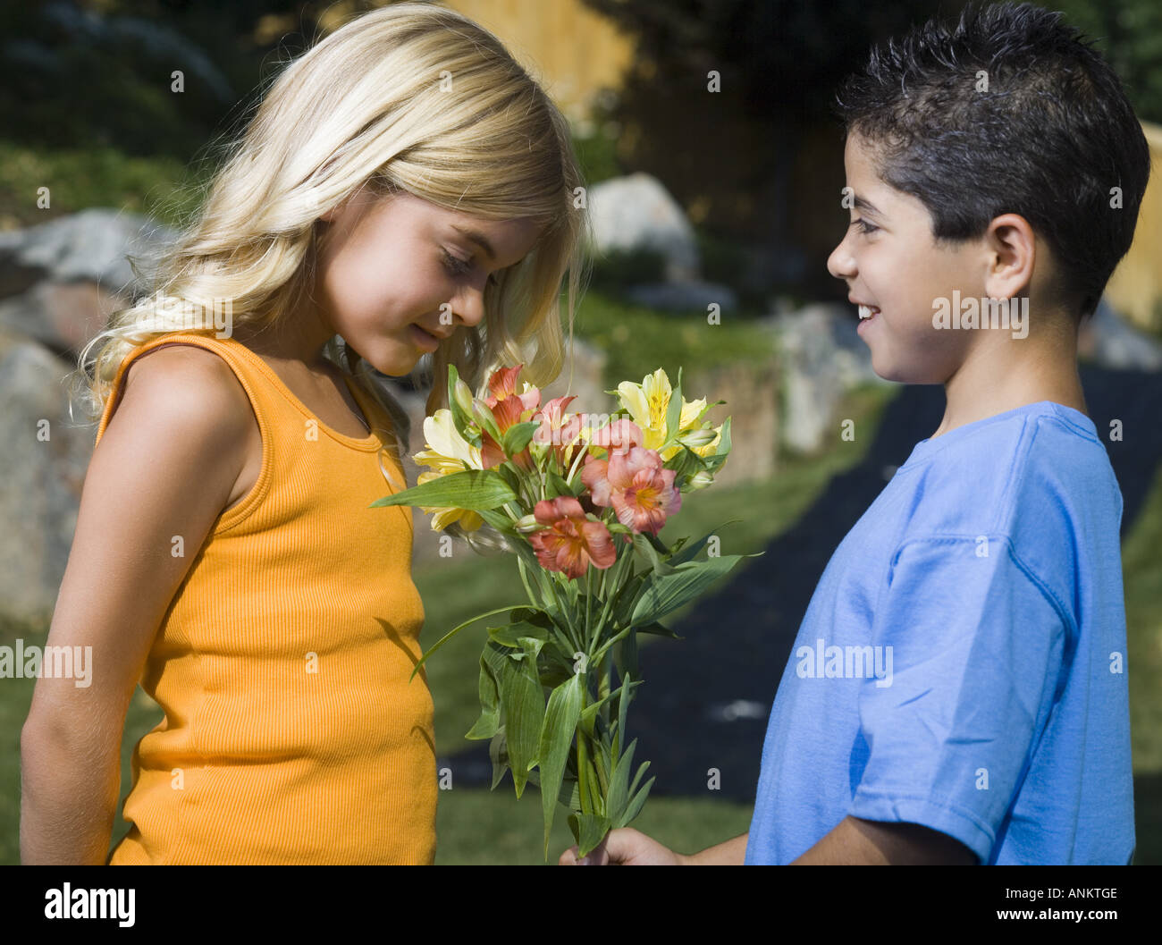 Profile of a boy giving flowers to a girl Stock Photo Alamy