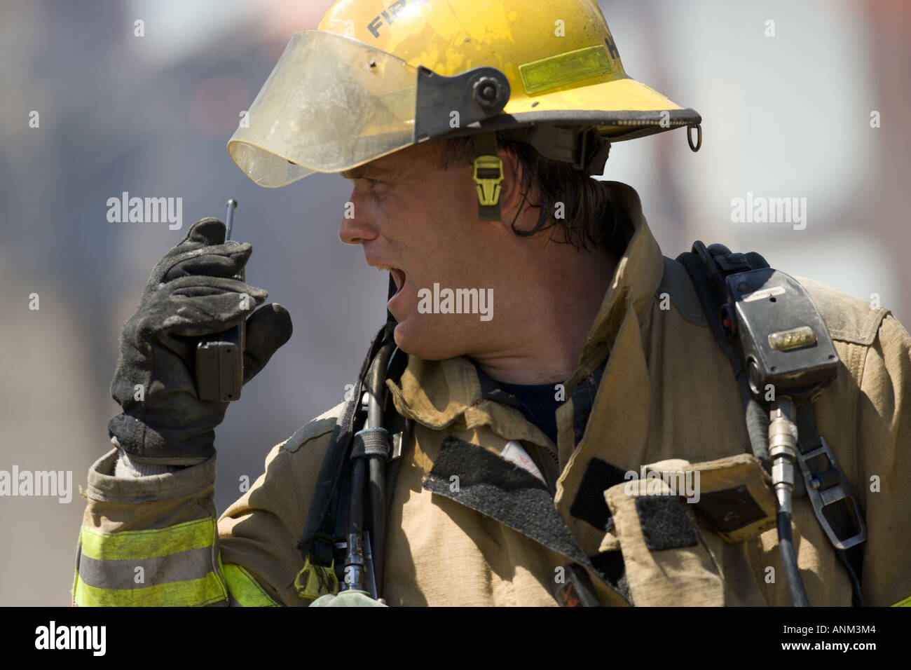 Close up of a firefighter holding a walkie talkie Stock Photo - Alamy