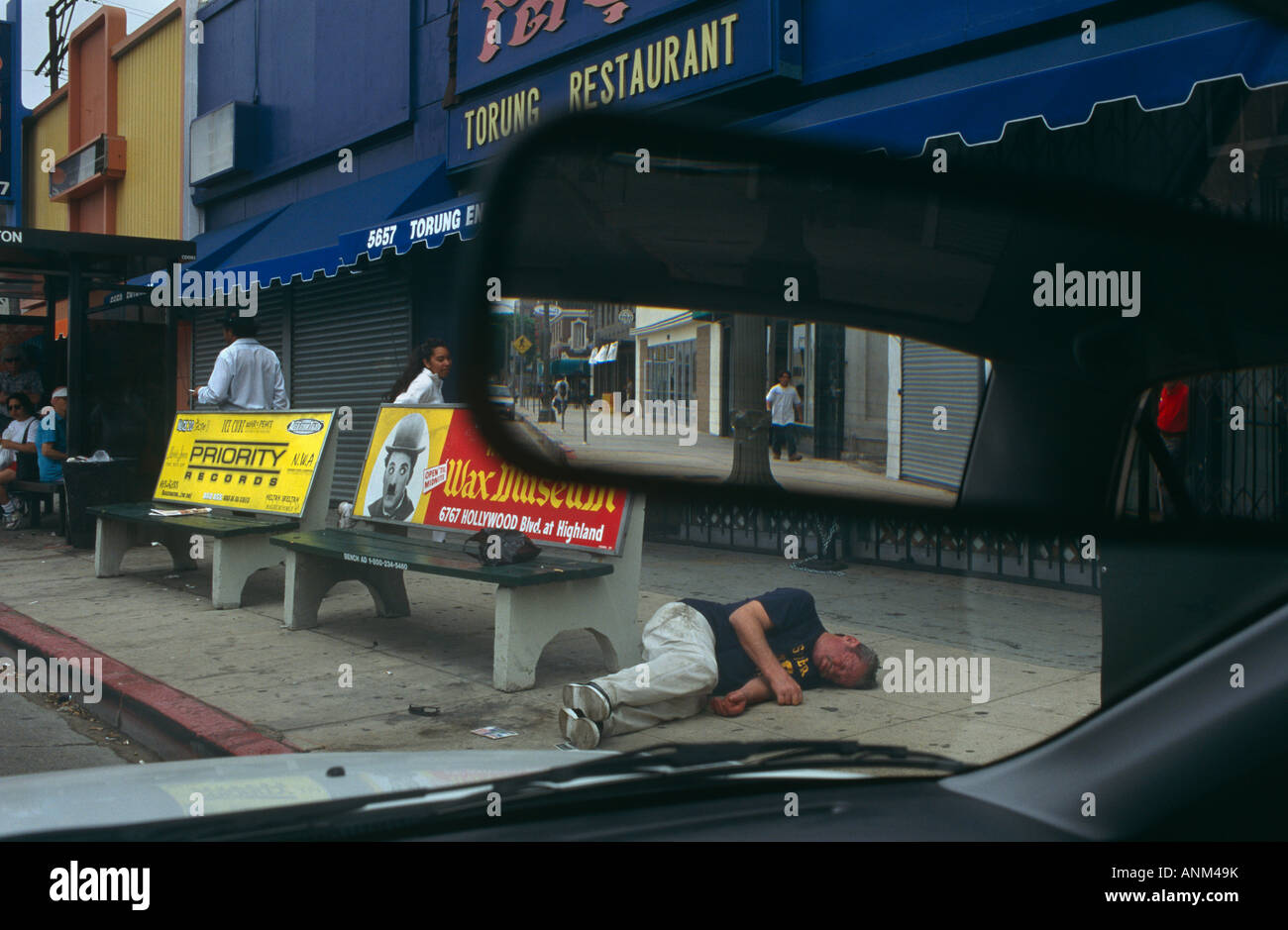 As normal life continues a man under the influence of alcohol lies