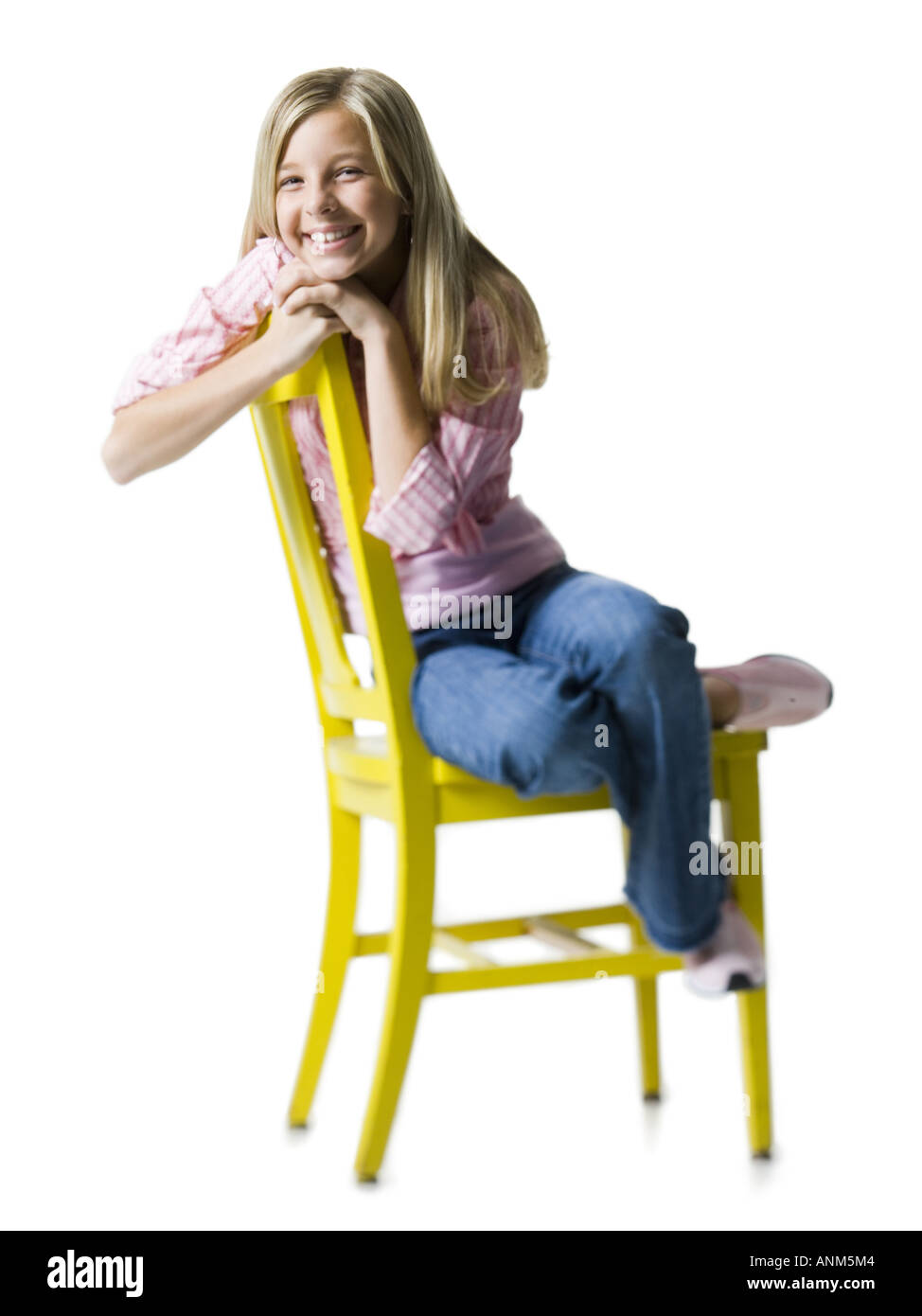 Portrait of a girl sitting on a chair and smiling Stock Photo - Alamy