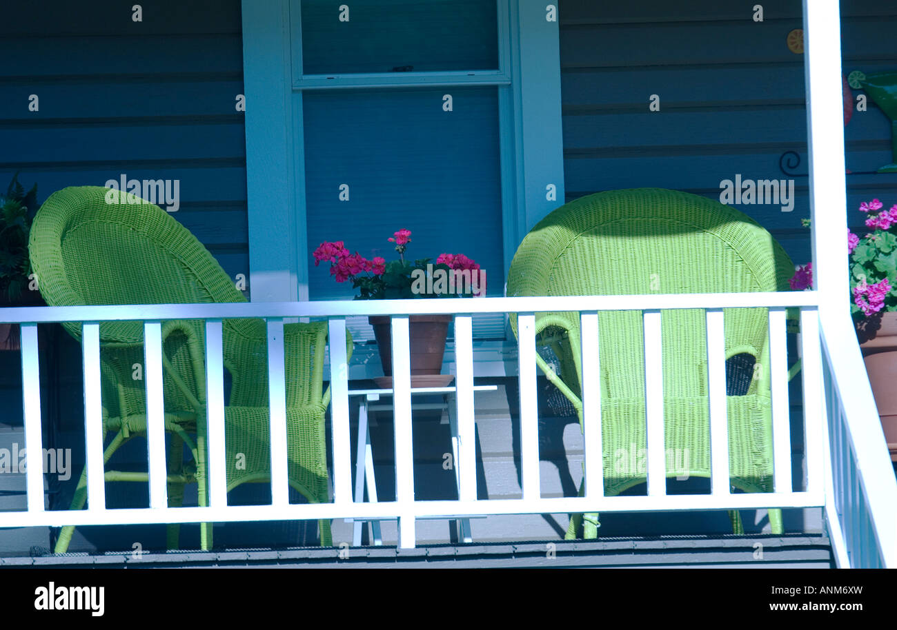 two green wicker chairs on porch Stock Photo - Alamy