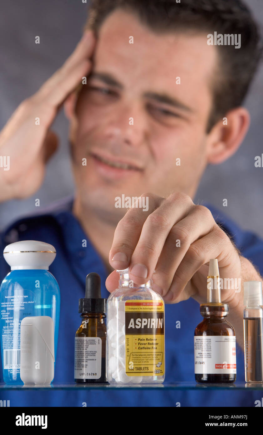 Man reaching for an aspirin in the medicine chest Stock Photo Alamy