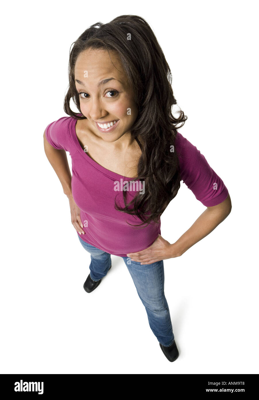 Portrait of a young woman standing with hands on her hips Stock Photo ...